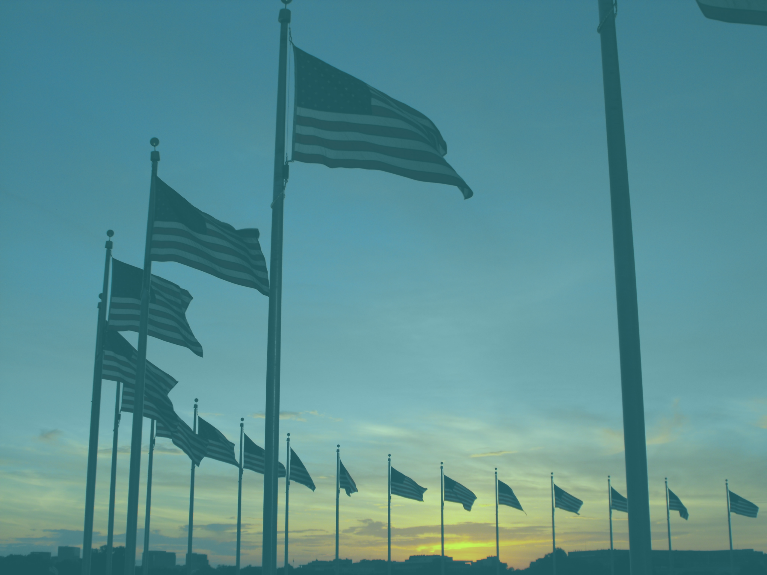 Photo: "Flags around monument at sunset", by Mommy110710, licensed under CC BY-SA 3.0. Hue modified from the original