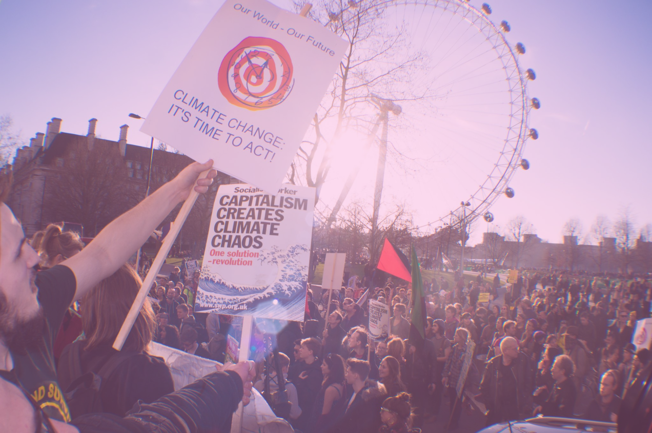 Photo: "Time To Act Climate Change London Protesters Creative Commons", by David B Young licensed under CC BY-NC 2.0. Hue modified from the original