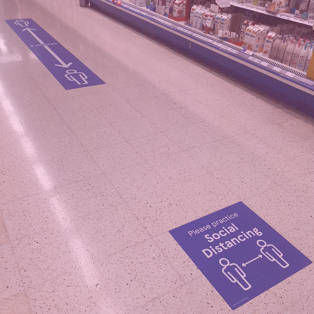 Photo: "Supermarket social distancing signs", by Ear-phone, licensed under CC BY-SA 4.0. Hue modified from the original