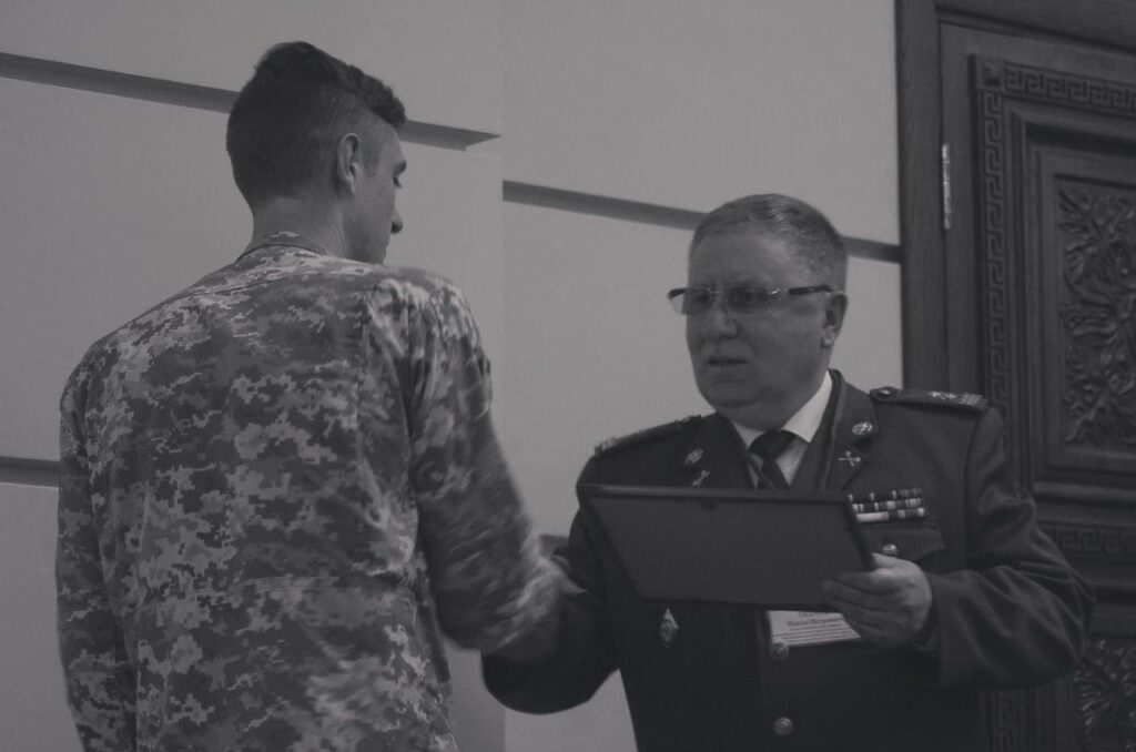 39 Screenshot of a photo from a Centuria Telegram post. In it, the NAA Chief is apparently handing Danylo Tikhomirov a commemorative plaque